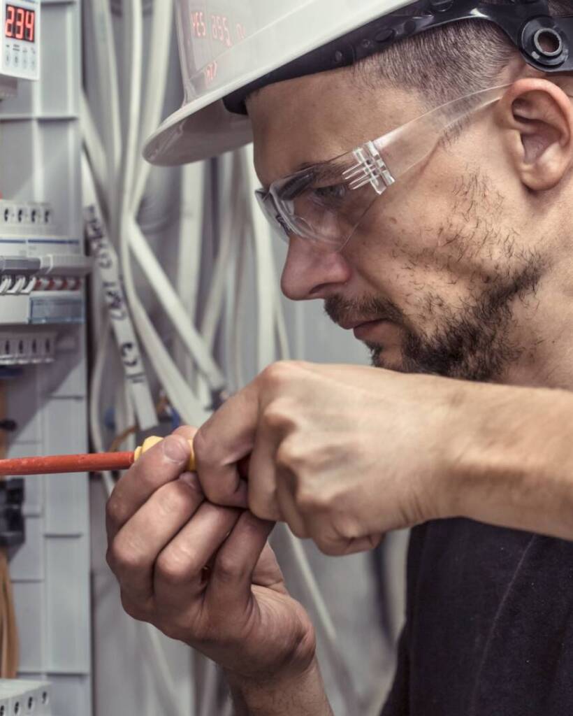 a-male-electrician-works-in-a-switchboard-with-an-electrical-connecting-cable.jpg